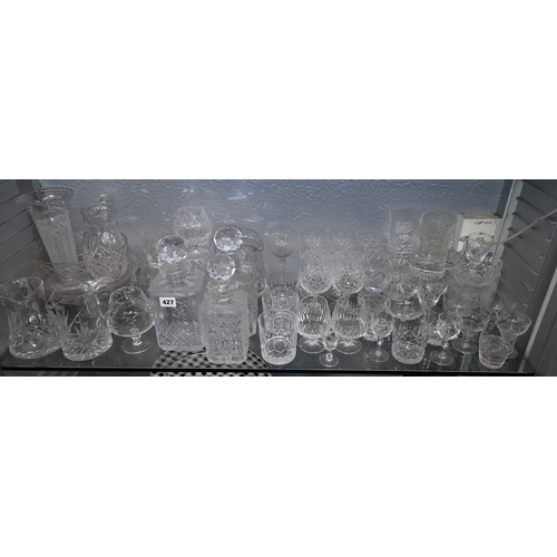 427 - SHELF OF CUT GLASS DECANTERS, BOWLS, WATER JUGS, AND TUMBLERS