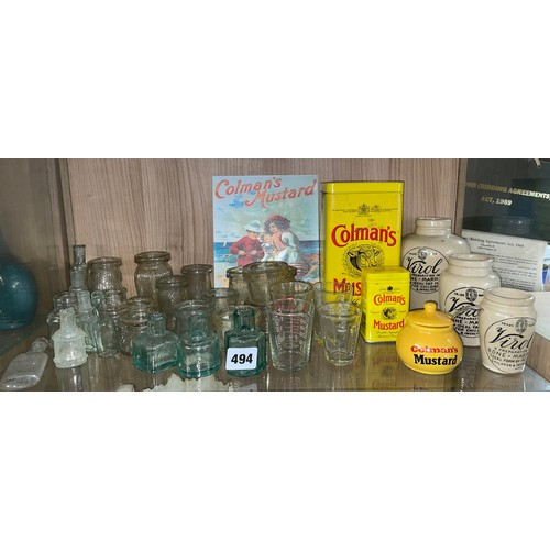 494 - SHELF OF APOCATHARY BOTTLES, MINIATURE GLASS MEASURES AND ADVERTISING WARES