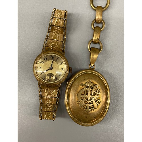 689 - GILT METAL OVAL LOCKET ON HEAVY LINK CHAIN AND A GILT METAL STRAP LADIES WRISTWATCH