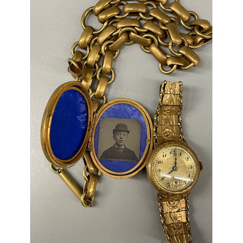 689 - GILT METAL OVAL LOCKET ON HEAVY LINK CHAIN AND A GILT METAL STRAP LADIES WRISTWATCH