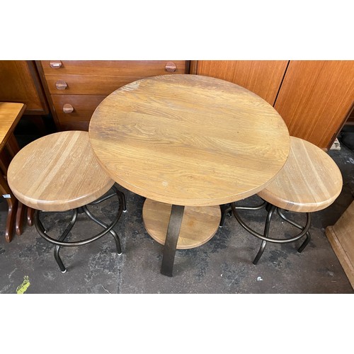 112 - SMALL CIRCULAR CROSS STRETCHER TABLE AND PAIR OF INDUSTRIAL STOOLS