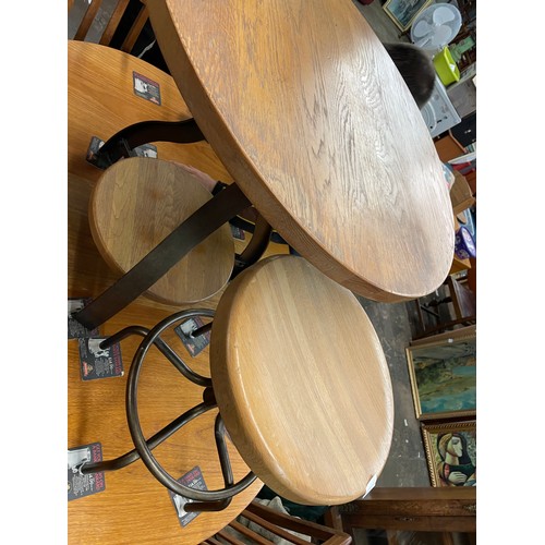 112 - SMALL CIRCULAR CROSS STRETCHER TABLE AND PAIR OF INDUSTRIAL STOOLS