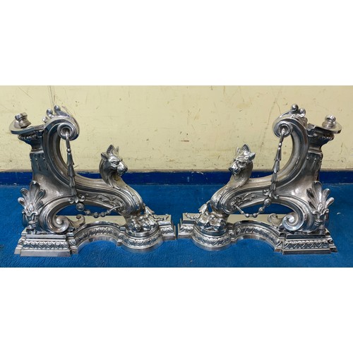 102 - PAIR OF POLISHED STEEL LION HEAD AND BELL HUSK CHENETS