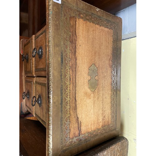 134 - SMALL EASTERN INSPIRED CHEST OF FOUR DRAWERS WITH BRASS DECORATED TOP