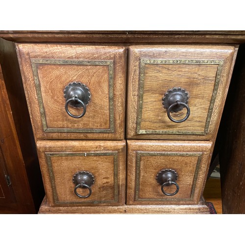 134 - SMALL EASTERN INSPIRED CHEST OF FOUR DRAWERS WITH BRASS DECORATED TOP