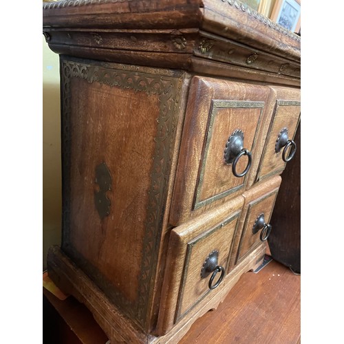 134 - SMALL EASTERN INSPIRED CHEST OF FOUR DRAWERS WITH BRASS DECORATED TOP