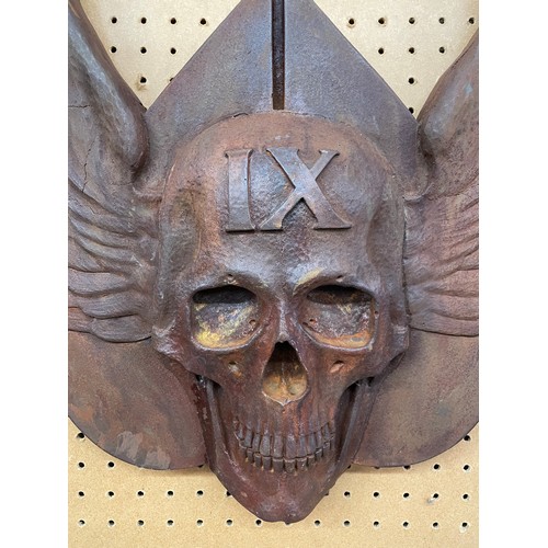 563 - PATINATED RUST POTTERY WINGED SKULL WALL HANGING