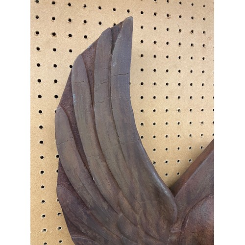 563 - PATINATED RUST POTTERY WINGED SKULL WALL HANGING