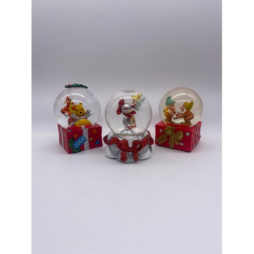 295 - THREE DISNEY ANNUAL CHRISTMAS SNOW GLOBES INCLUDING 2008,2009 AND 2010