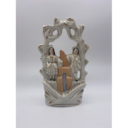 554 - STAFFORDSHIRE FLAT BACK FIGURE OF A COUPLE UNDER ARCH AND ONE SMALLER FIGURE 34.5CM H AND 24.5CM H