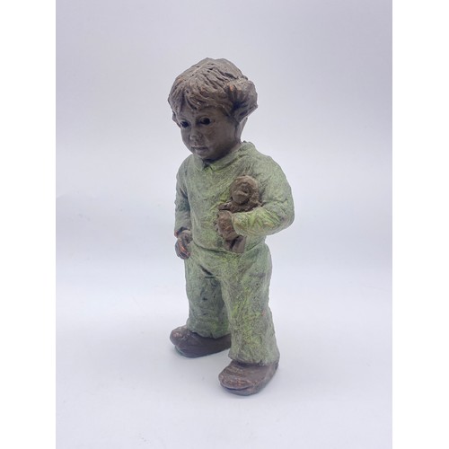 519 - GEERT KUNEN CERAMIC FIGURE OF CHILD WITH DOLL 16CM H