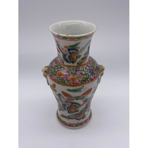 520 - SMALL FAMILLE ROSE BALUSTER VASE DECORATED WITH BUTTERFLIES 14CM H