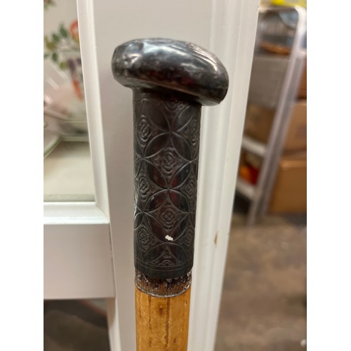 586 - LIGHT WOOD WALKING CANE WITH EASTERN WHITE METAL POMMEL