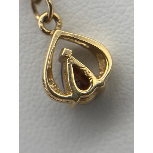 575 - YELLOW METAL AND RED STONE TEAR DROP PENDANT ETCHED 14K A ON 14K CHAIN 2.1G OVERALL