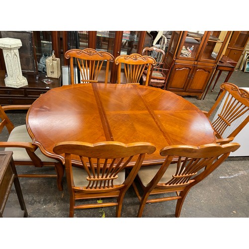 79 - CHERRY WOOD SERPENTINE CROSS BANDED DINING TABLE AND SIX CHAIRS