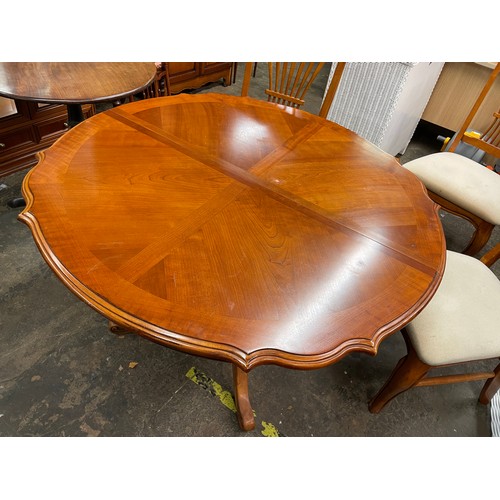 79 - CHERRY WOOD SERPENTINE CROSS BANDED DINING TABLE AND SIX CHAIRS