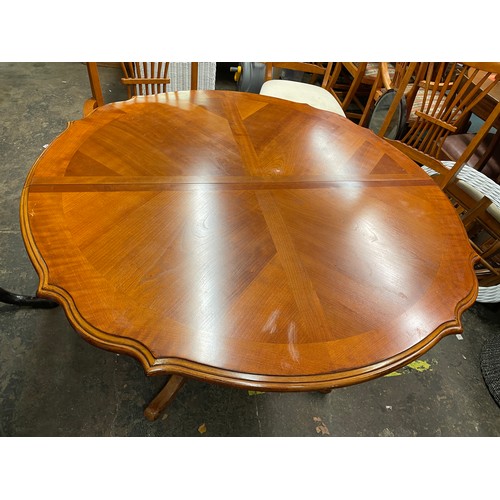 79 - CHERRY WOOD SERPENTINE CROSS BANDED DINING TABLE AND SIX CHAIRS