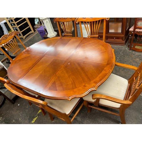 79 - CHERRY WOOD SERPENTINE CROSS BANDED DINING TABLE AND SIX CHAIRS