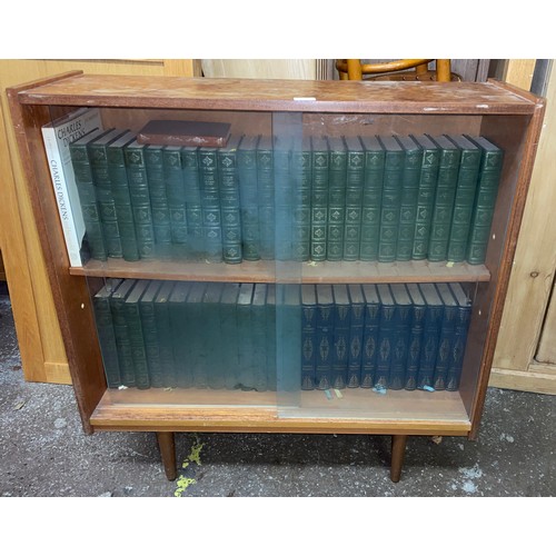 159 - 1960S TEAK SLIDING DOOR CABINET FULL OF CHARLES DICKENS LIBRARY AND CLASSIC NOVELS