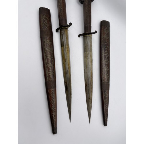 485 - PAIR OF EASTERN ROSE WOOD AND BRASS INLAID DECORATIVE DAGGERS