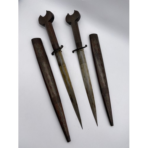 485 - PAIR OF EASTERN ROSE WOOD AND BRASS INLAID DECORATIVE DAGGERS