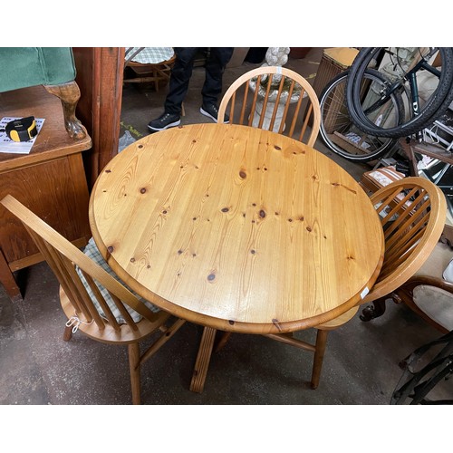 75 - PINE CIRCULAR PEDESTAL BREAKFAST TABLE AND HOOP BACK CHAIRS