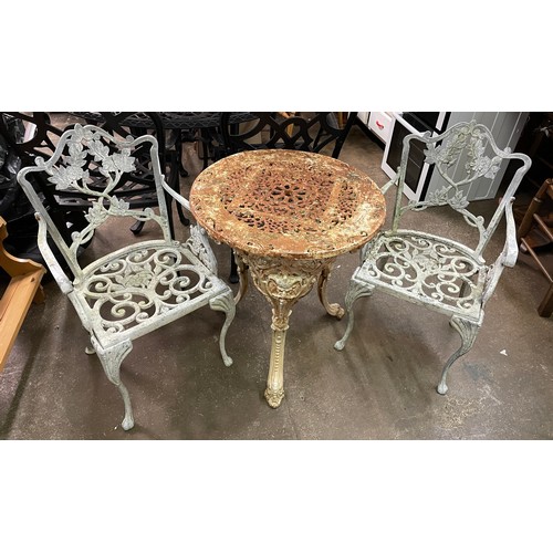 73 - CAST METAL VICTORIAN PATIO TABLE AND PAIR OF ARMCHAIRS