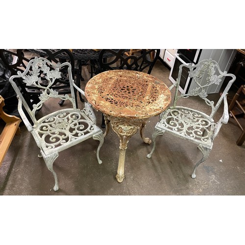 73 - CAST METAL VICTORIAN PATIO TABLE AND PAIR OF ARMCHAIRS