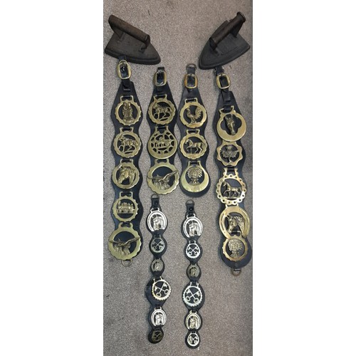 263 - HORSE BRASSES ON LEATHER STRAPS AND TWO FLAT IRONS