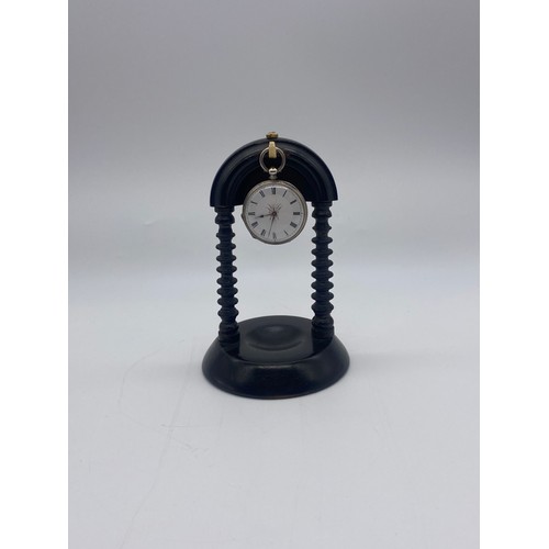 508 - SILVER ENGRAVED FOB WATCH ON EBONISED TURNED MANTLE HOLDER