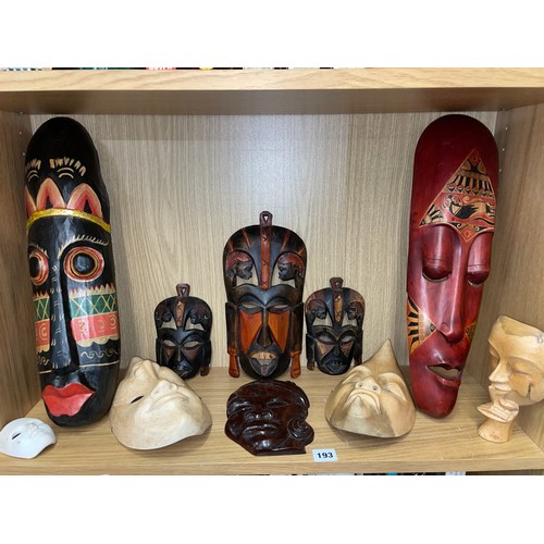 193 - SHELF OF CARVED AND POLYCHROME PAINTED FACE MASKS