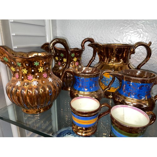 199 - SHELF OF COPPER LUSTRE RESIST AND PAINTED JUGS AND MUGS