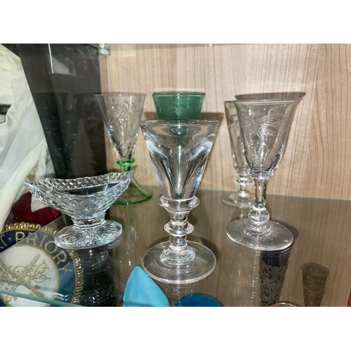 284 - TWO SHELVES OF ANTIQUE AND LATER CUT AND PRESSED GLASSWARE INCLUDING PEDESTAL SALT, SPILL VASES, GOB... 