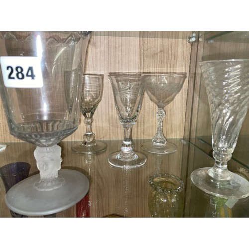 284 - TWO SHELVES OF ANTIQUE AND LATER CUT AND PRESSED GLASSWARE INCLUDING PEDESTAL SALT, SPILL VASES, GOB... 