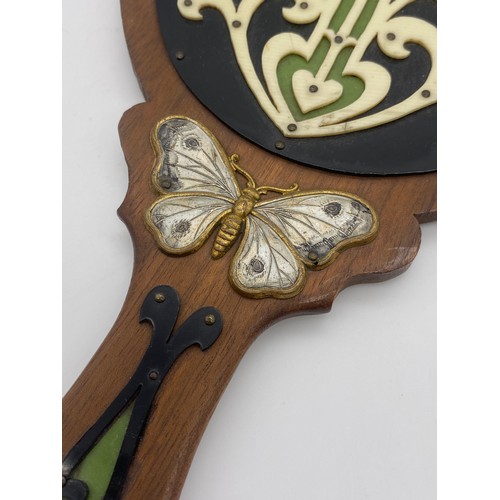 461 - ART NOUVEAU WOODEN AND BUTTERFLY APPLIED DECORATIVE BACKED HAND MIRROR