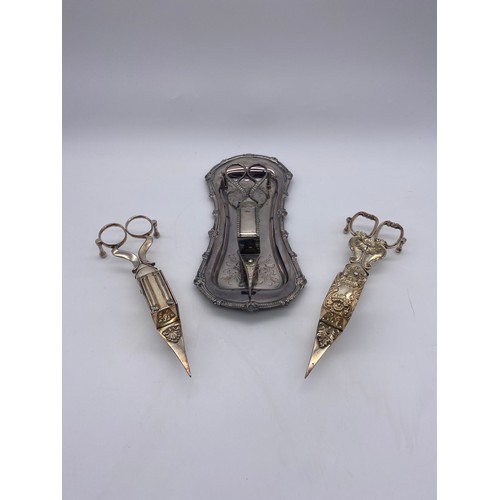 438 - EARLY 19TH CENTURY CANDLE WICK SNUFFERS ON TRAY AND TWO OTHER EXAMPLES