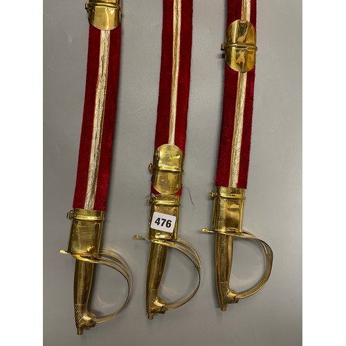 476 - THREE BRASS MOUNTED INDIAN CEREMONIAL SWORDS IN RED SHEATH SCABBARD