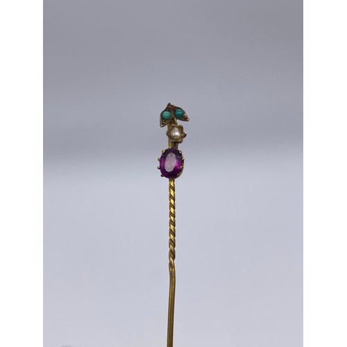 577 - CASED UNMARKED YELLOW METAL AMETHYST AND SEED PEARL STICK PIN