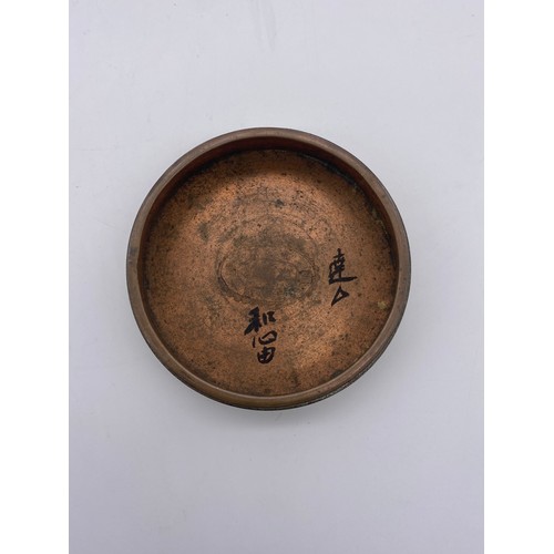 584 - ORIENTAL ENGRAVED CYLINDRICAL BOX, SHALLOW BRASS DISHES AND SMALL BHUDDAVISTA