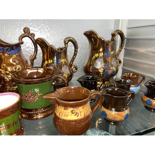 233 - SHELF OF COPPER LUSTRE RESIST AND PAINTED JUGS AND MUGS