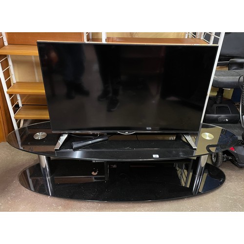 83 - JVC COLOUR TV ON OVAL GLASS MEDIA UNIT