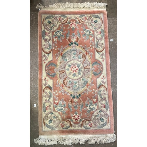 151 - PINK FLORAL ROLLED RUG