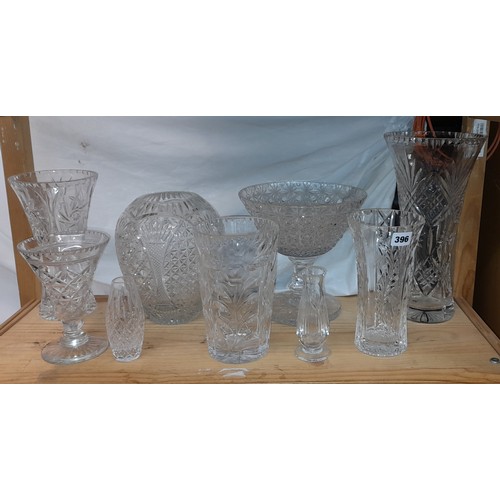 396 - TWO SHELVES OF CUT AND ETCHED GLASS - PEDESTAL BOWLS AND VASE