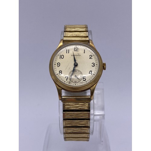 9CT GOLD CASED GARRARD WRISTWATCH ON PLATED BARK EFFECT ELASTICATED STRAP