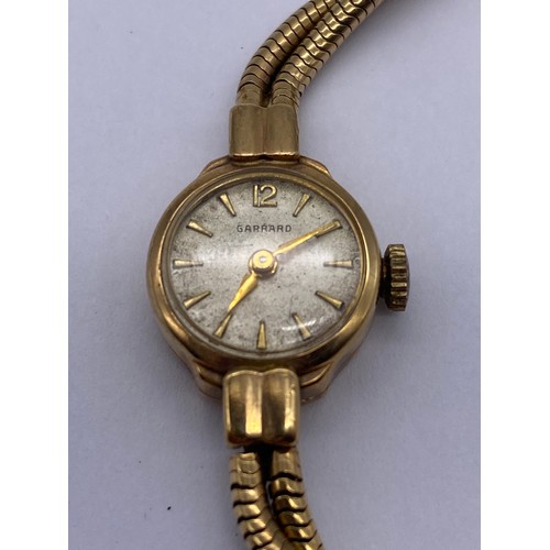 561 - LADIES GARRARD CIRCULAR WRISTWATCH ON 9CT GOLD TWIN HERRINGBONE STRAP 15.5G OVERALL