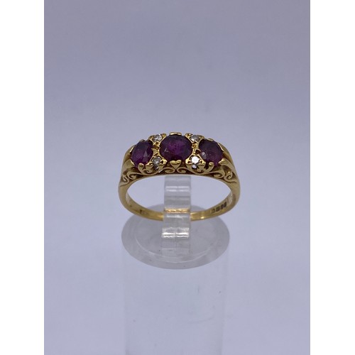 567 - 18CT GOLD THREE STONE RUBY AND DIAMOND GYPSY STYLE RING 4.6G APPROX