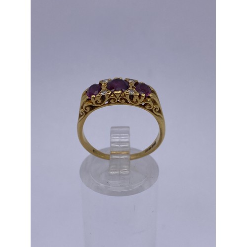 567 - 18CT GOLD THREE STONE RUBY AND DIAMOND GYPSY STYLE RING 4.6G APPROX