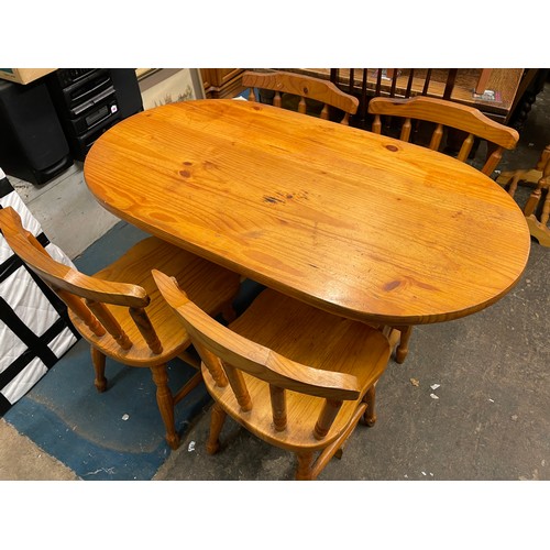 42 - PINE OVAL KITCHEN TABLE AND FOUR SPINDLE BACK CHAIRS