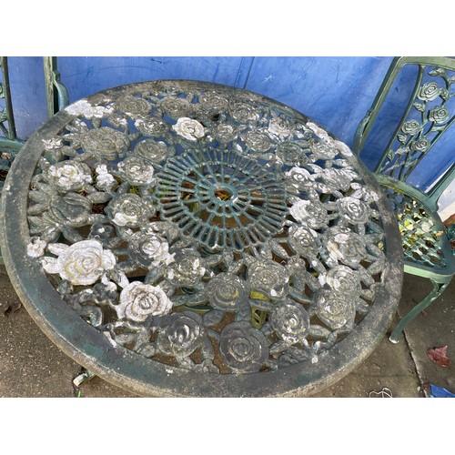 104 - GREEN CAST METAL VICTORIAN STYLE CIRCULAR TABLE AND TWO ARMCHAIRS