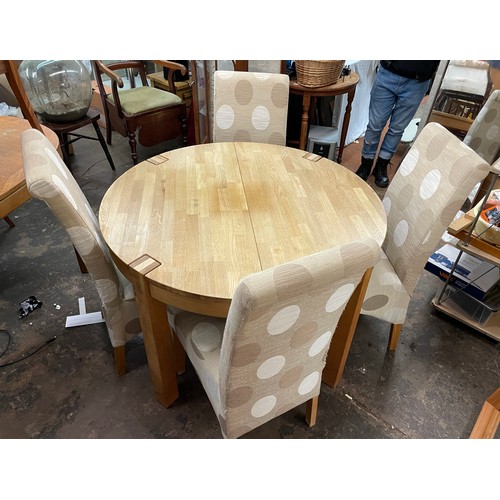 138 - LIGHT OAK CIRCULAR DINING TABLE AND FOUR FABRIC COVERED HIGH BACK CHAIRS